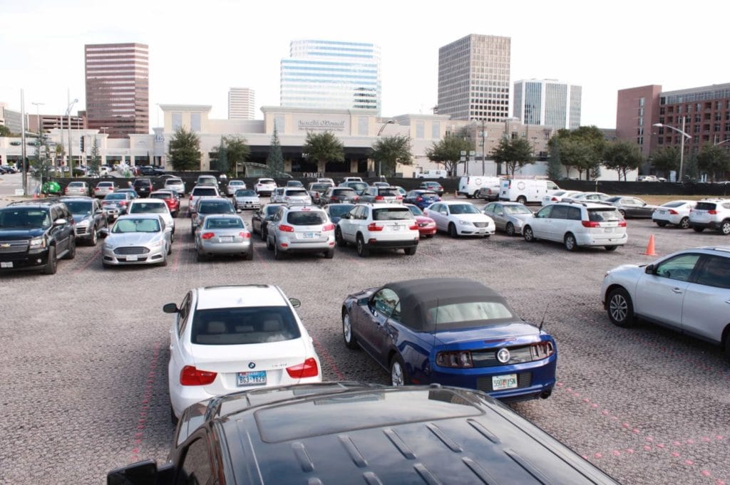 Large parking lot filled with cars at a shopping center. 