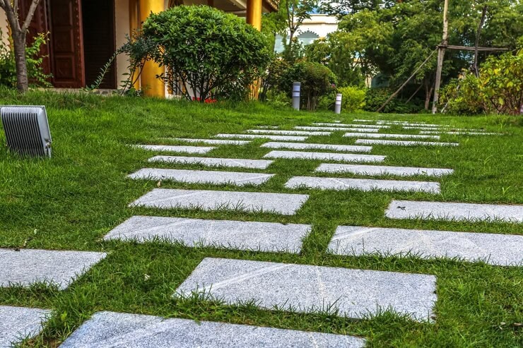 Large stepping stones placed on grass to form an interactive landscape