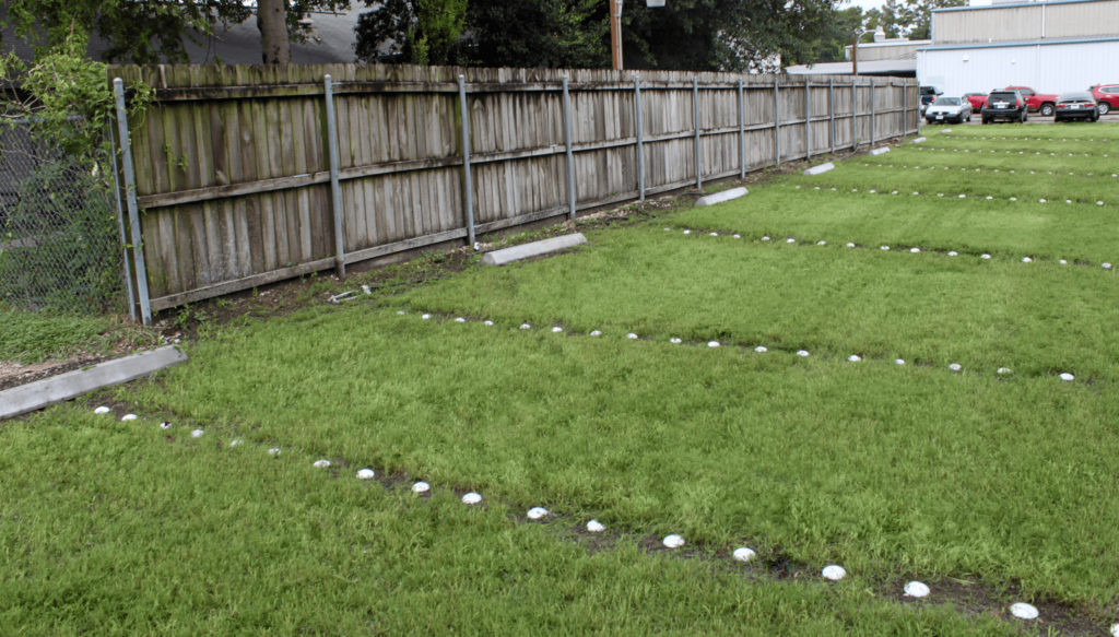 an eco-friendly park design idea that has created a parking lot with grass