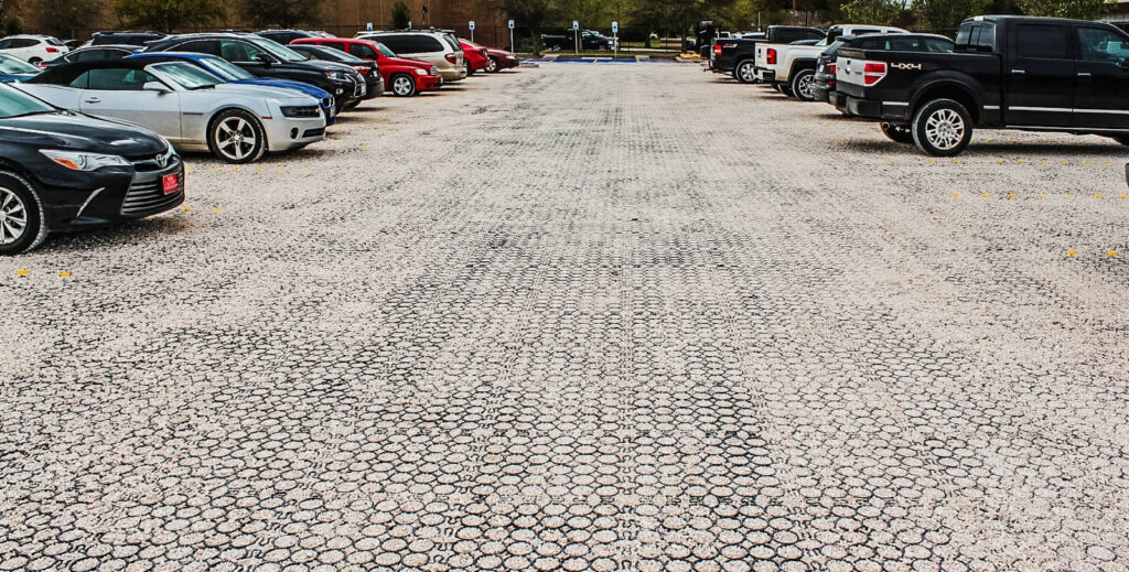 an image of permeable pavers from TRUEGRID® in a large gravel parking lot