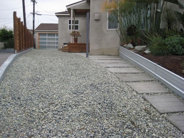 an image of a gravel walkway and driveway that uses stone steps on the side