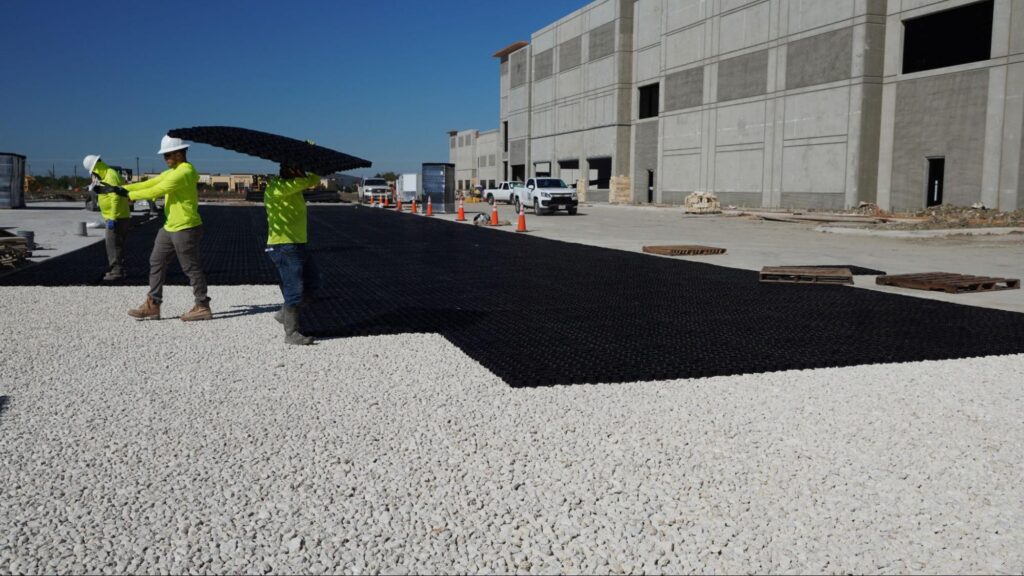 an image of workers installing permeable pavers from TRUEGRID® for their rental yard