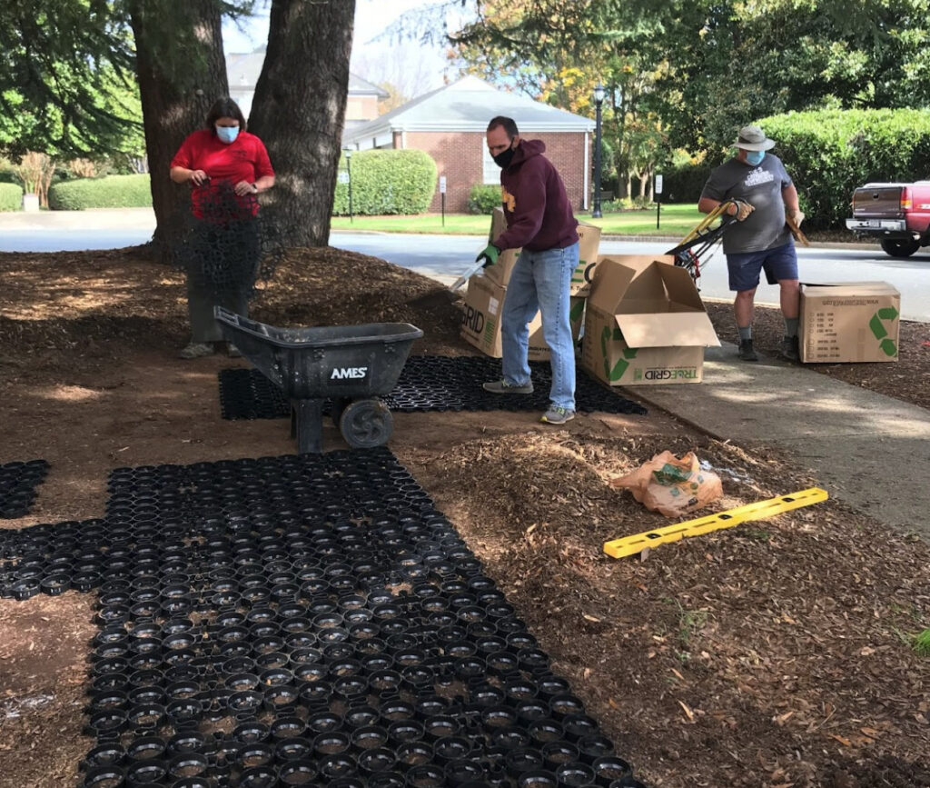 Permeable pavers line a walkway during installation.