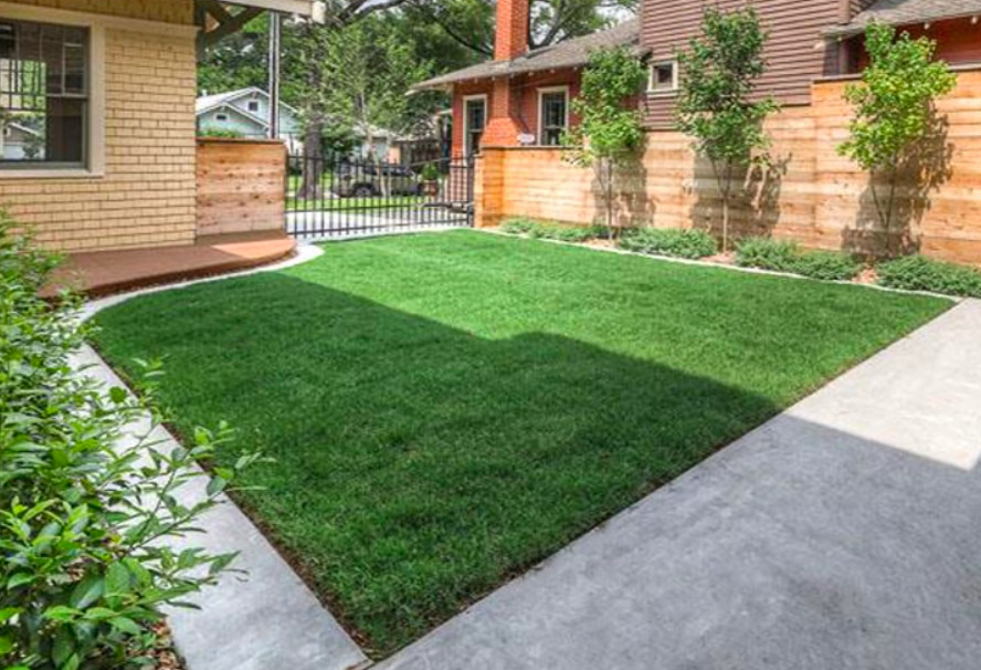 Grass infill permeable paver driveway with concrete pad and apron.