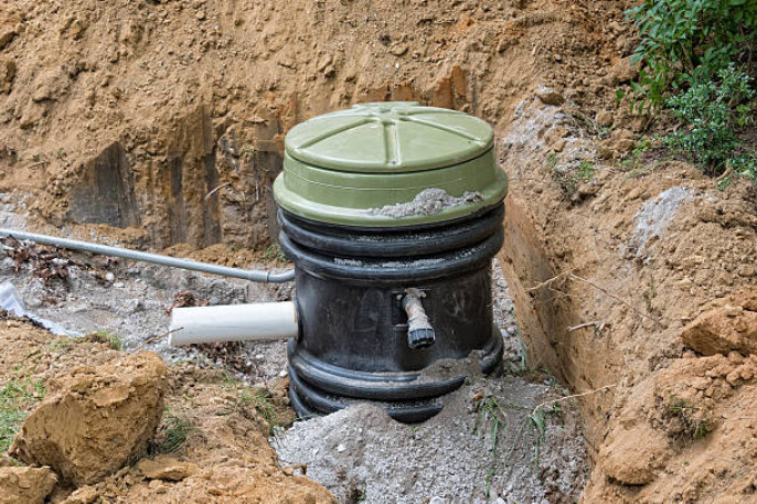 Installation of a combined sewage system underway near a residential property.