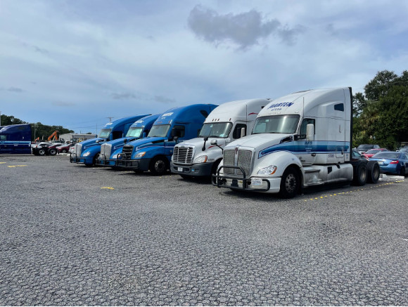 Trucks lined up on a permeable paver lot.