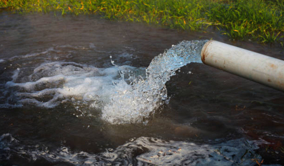 A drainage pipe pumps water into an overflow area. 