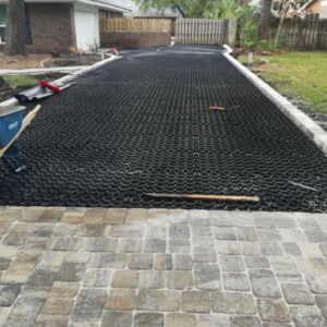 A driveway undergoing installation with a permeable paver system.