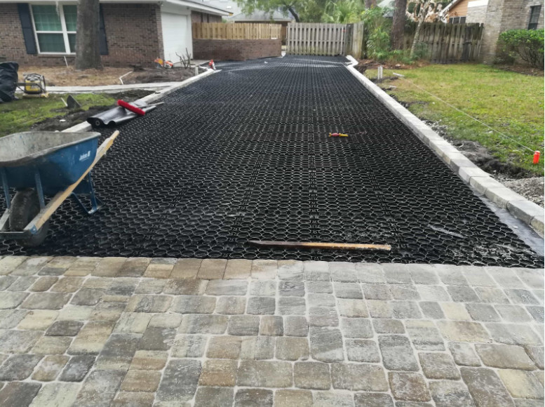 A driveway undergoing installation with a permeable paver system.