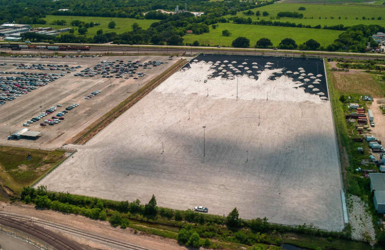 An expansive parking lot in the early phases of construction.